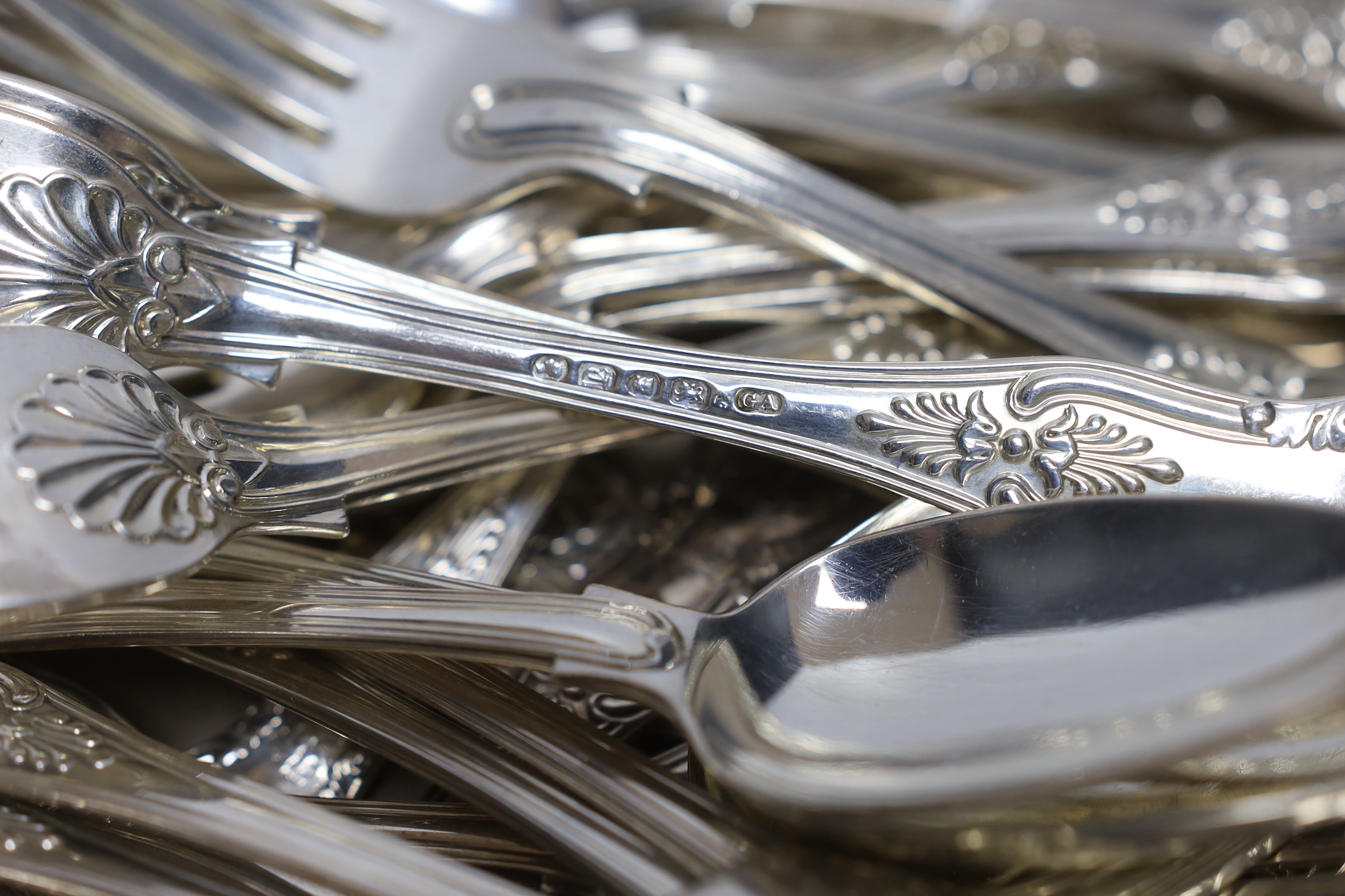 A part canteen of Victorian silver King's pattern flatware by George Adams, comprising twelve table forks, twelve dessert spoons, six dessert forks, one sauce ladle and four serving spoons, London, 1854, together with fo